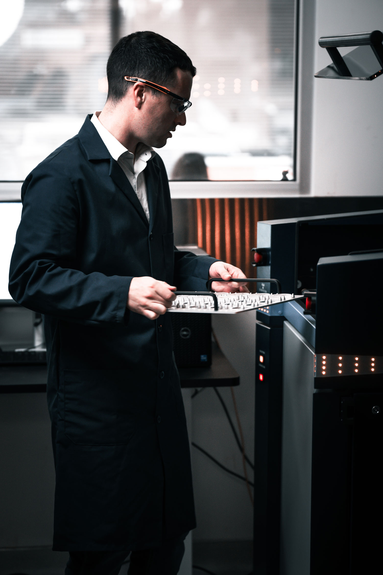 Tech holding a sample tray to be used in the D8 endeavor